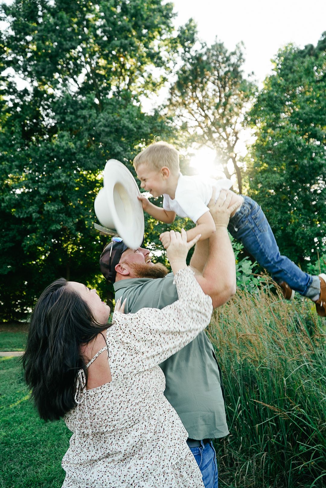 Playful sequence of parent and child together outdoors in a sunny green setting. Film inspired.