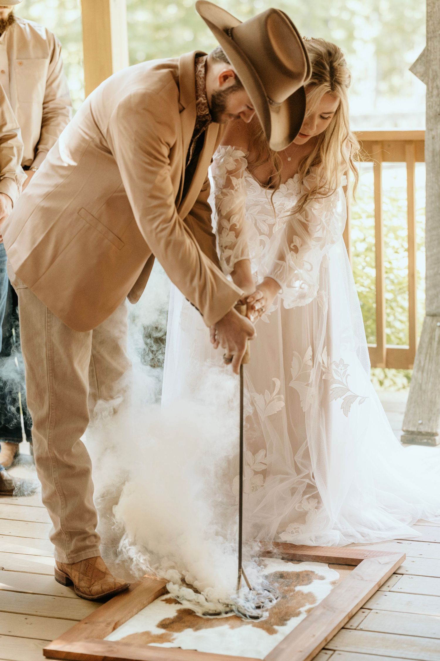 photograph of branding during the ceremony at the. barn at big oak in franklin georgia