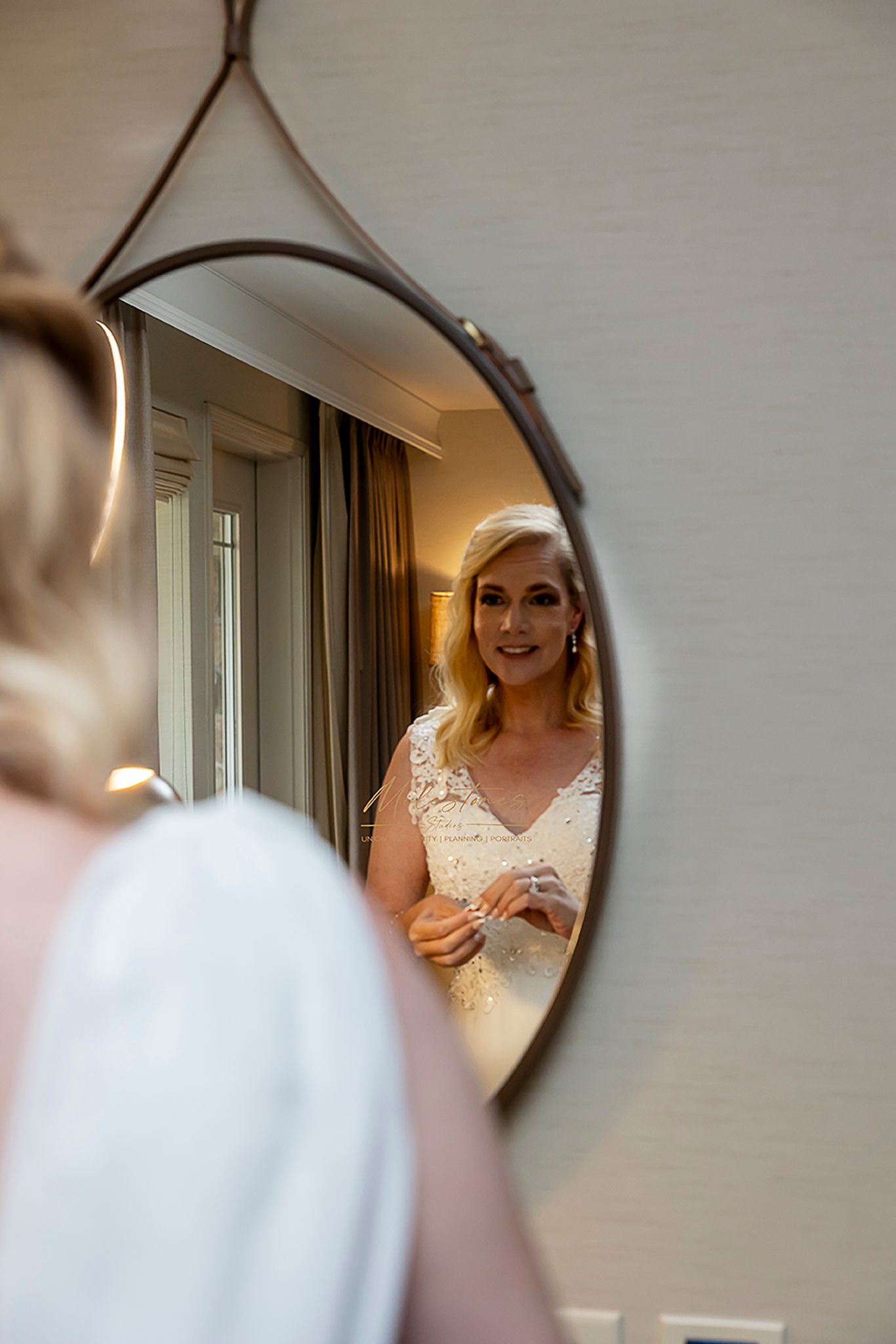 Bride looking in mirror