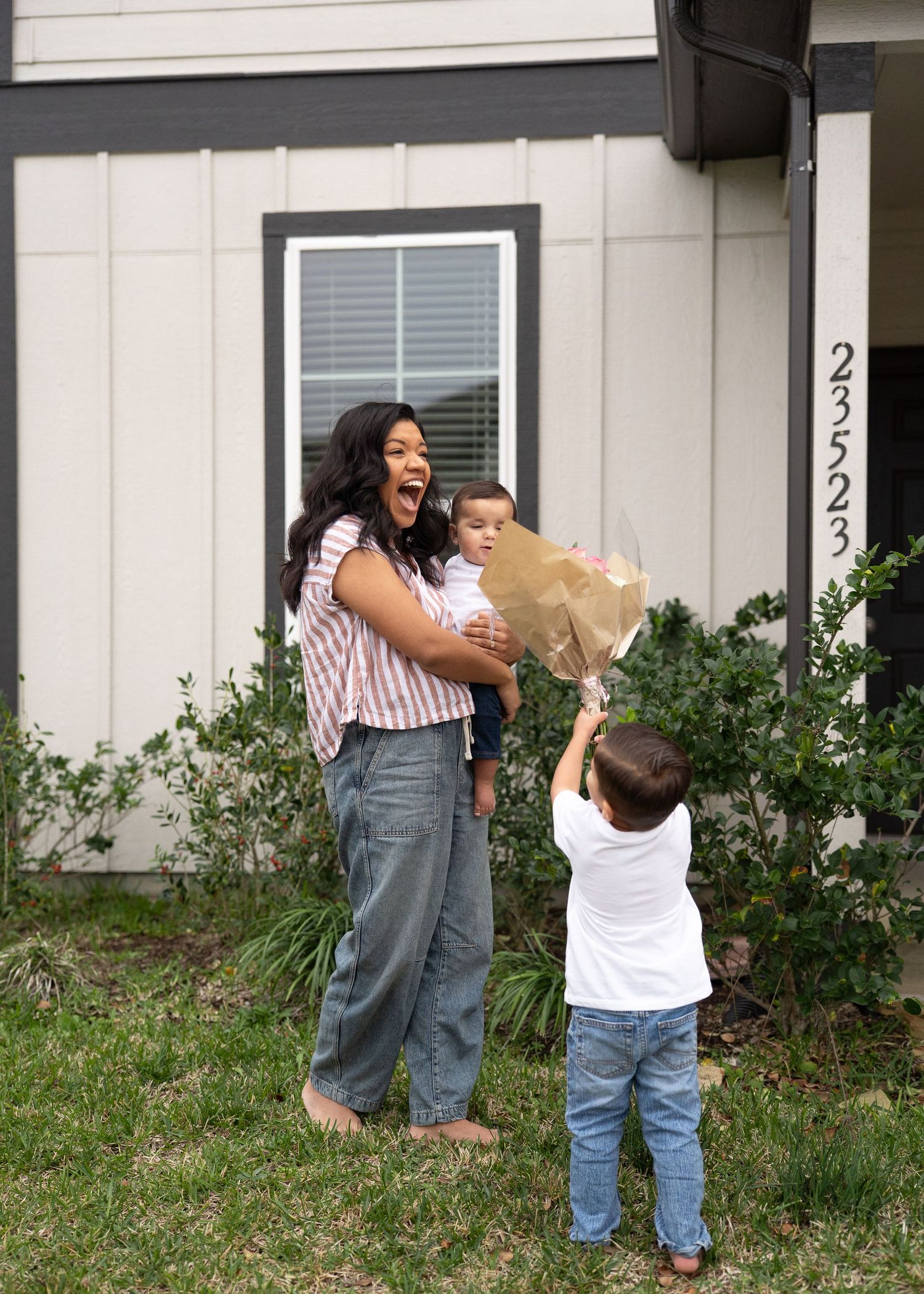 Emerson Family laughing together during gender reveal session in their North Houston home