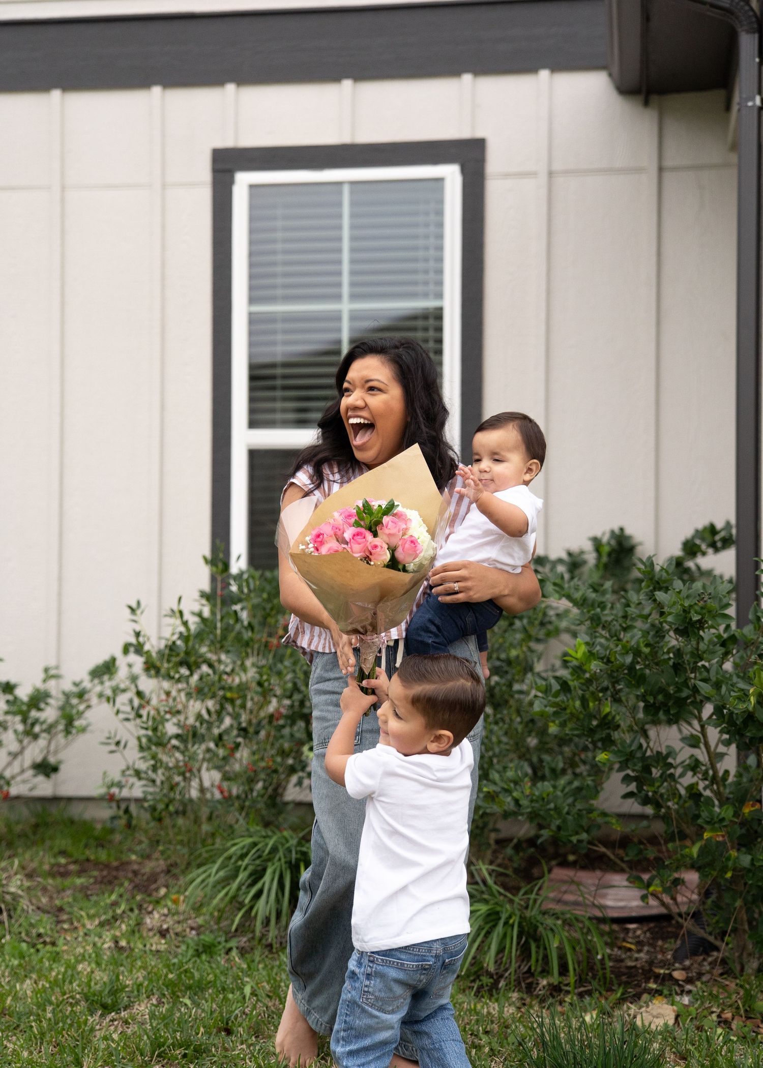 Emerson Family laughing together during gender reveal session in their North Houston home