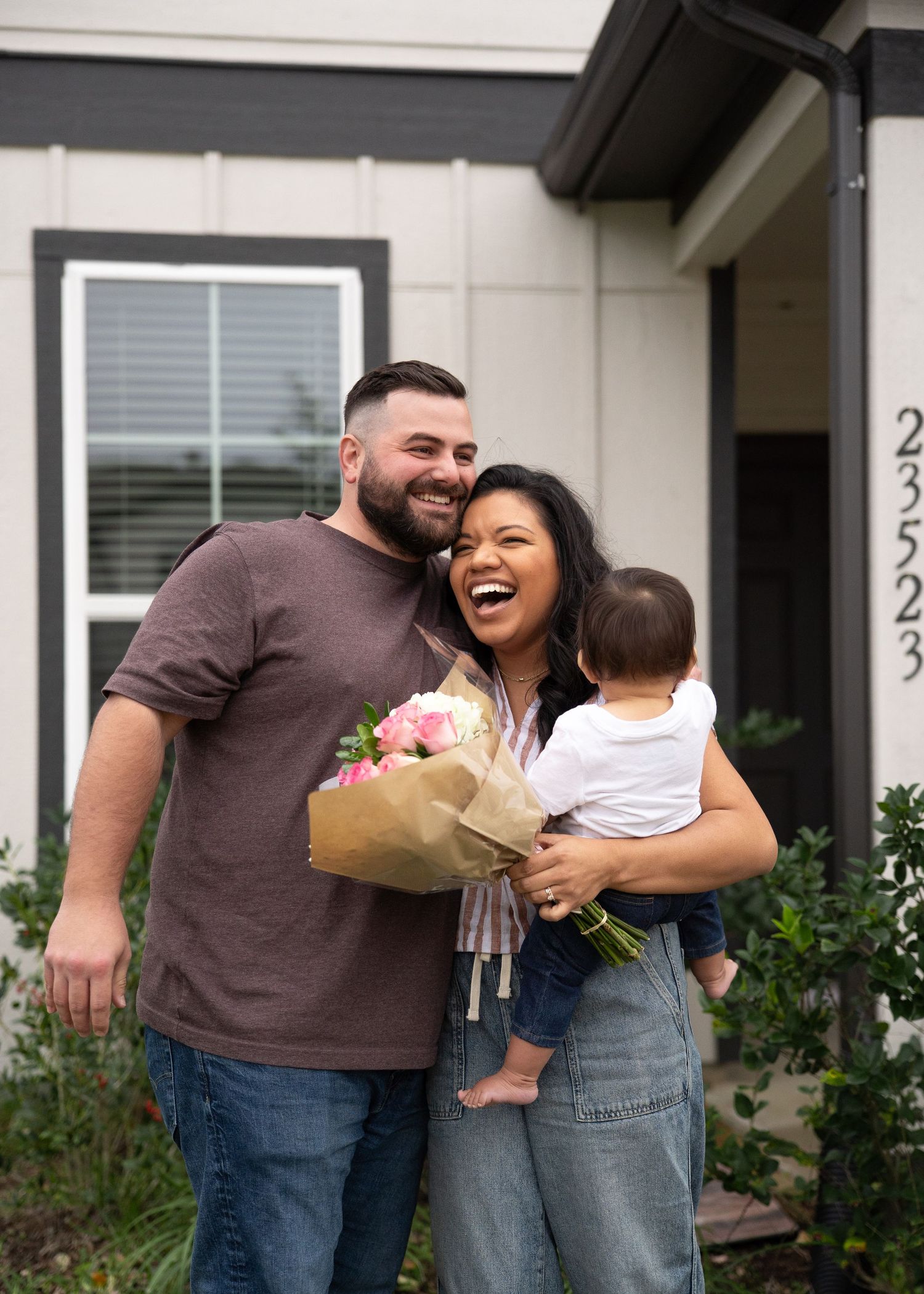 Emerson Family laughing together during gender reveal session in their North Houston home
