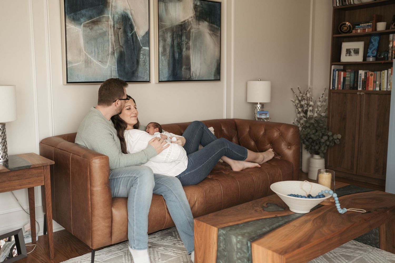 New parenents with a newborn baby during an in home newborn session.