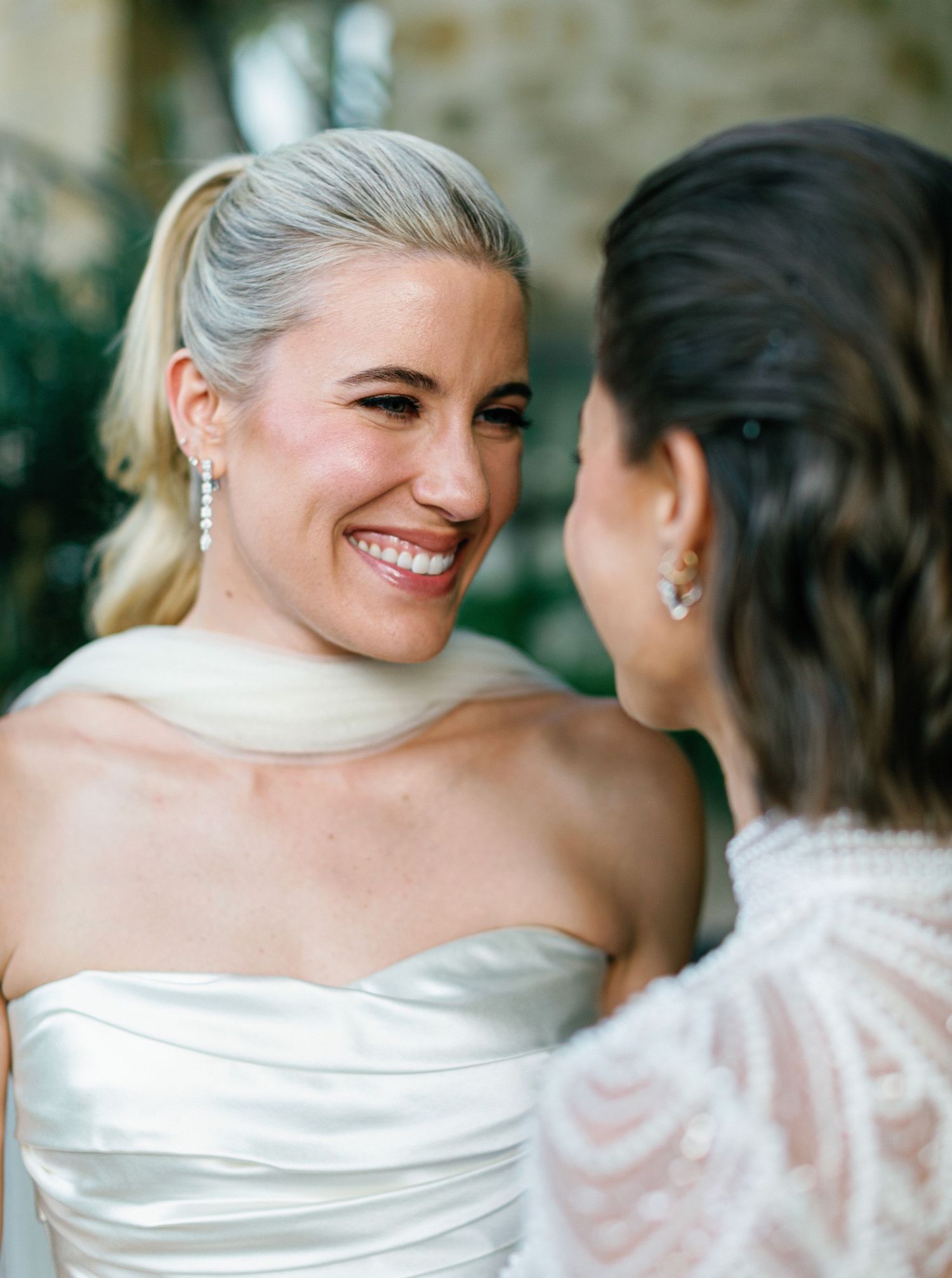 A series of candid wedding photos showing tender moments between two people in white formal attire.