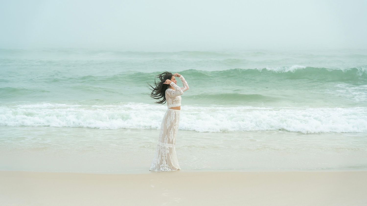 Serene ocean waves create perfect backdrop for beach photography session.