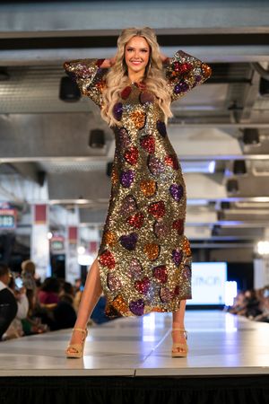 Sequined multicolor party dress sparkles under runway lights.