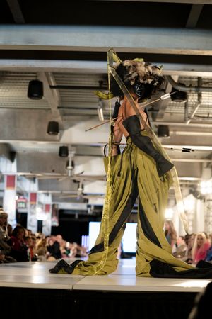 A series of photos showing a performer in yellow pants doing acrobatic dance moves on a low platform.