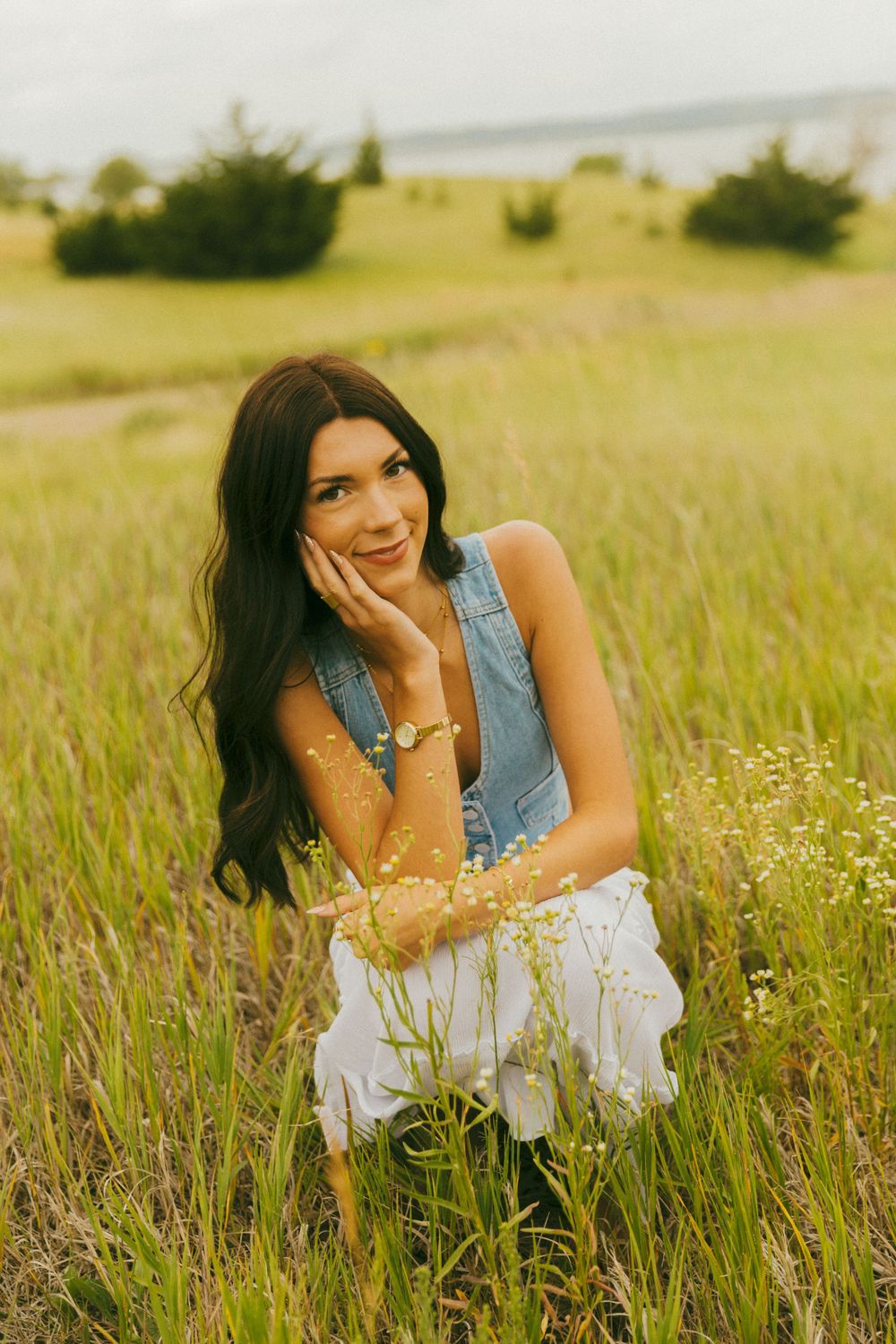 Playful poses among wildflowers in a rustic field setting during golden hour.