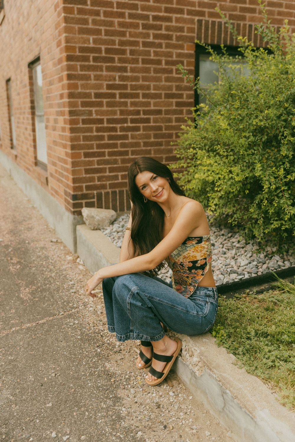 Casual outdoor portraits against a brick wall with denim and natural lighting.