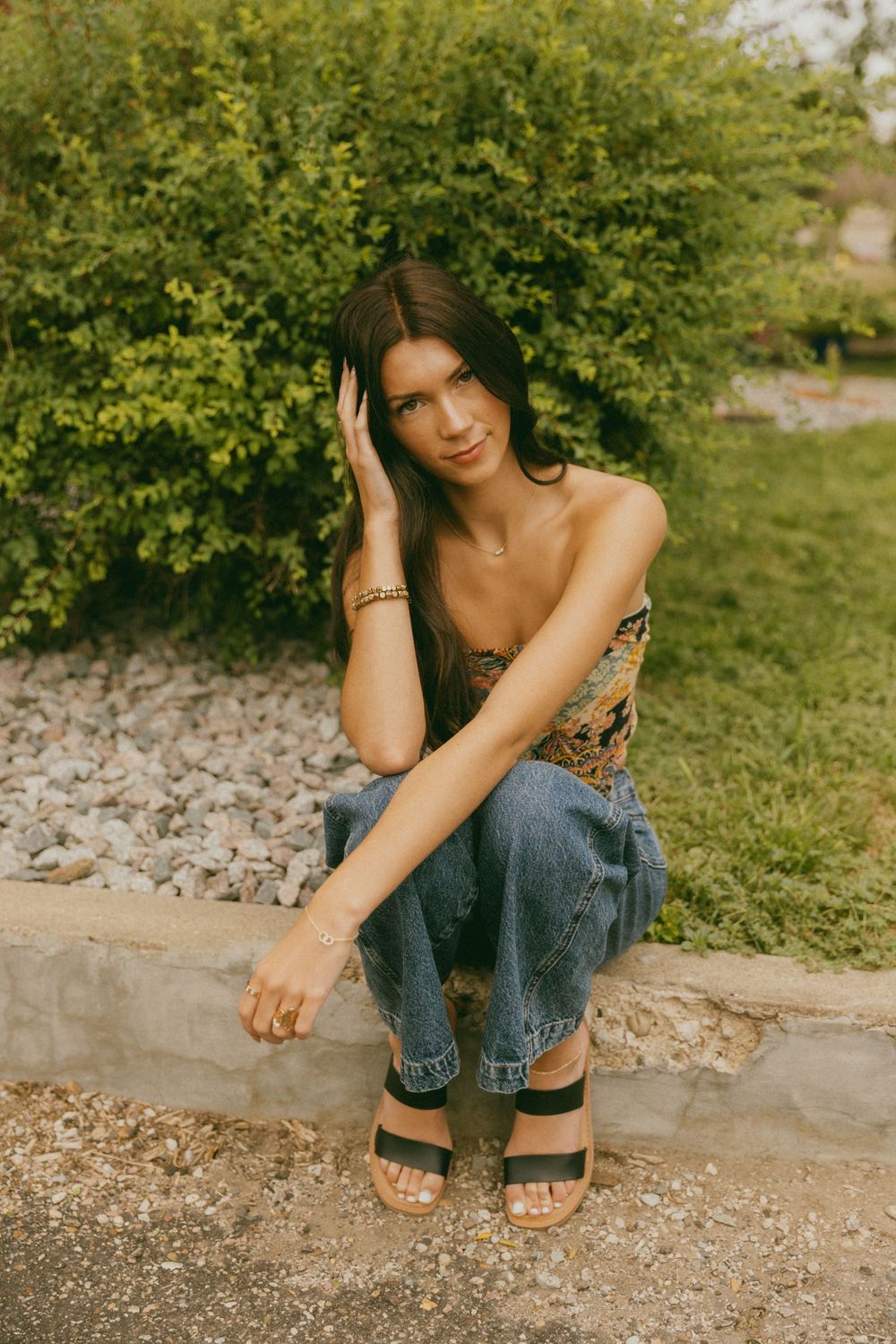 Relaxed poses on concrete steps with casual denim and summer vibes.
