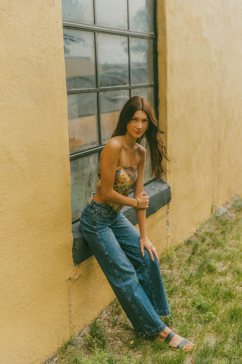 Artistic portraits against a yellow wall showcasing casual denim style.