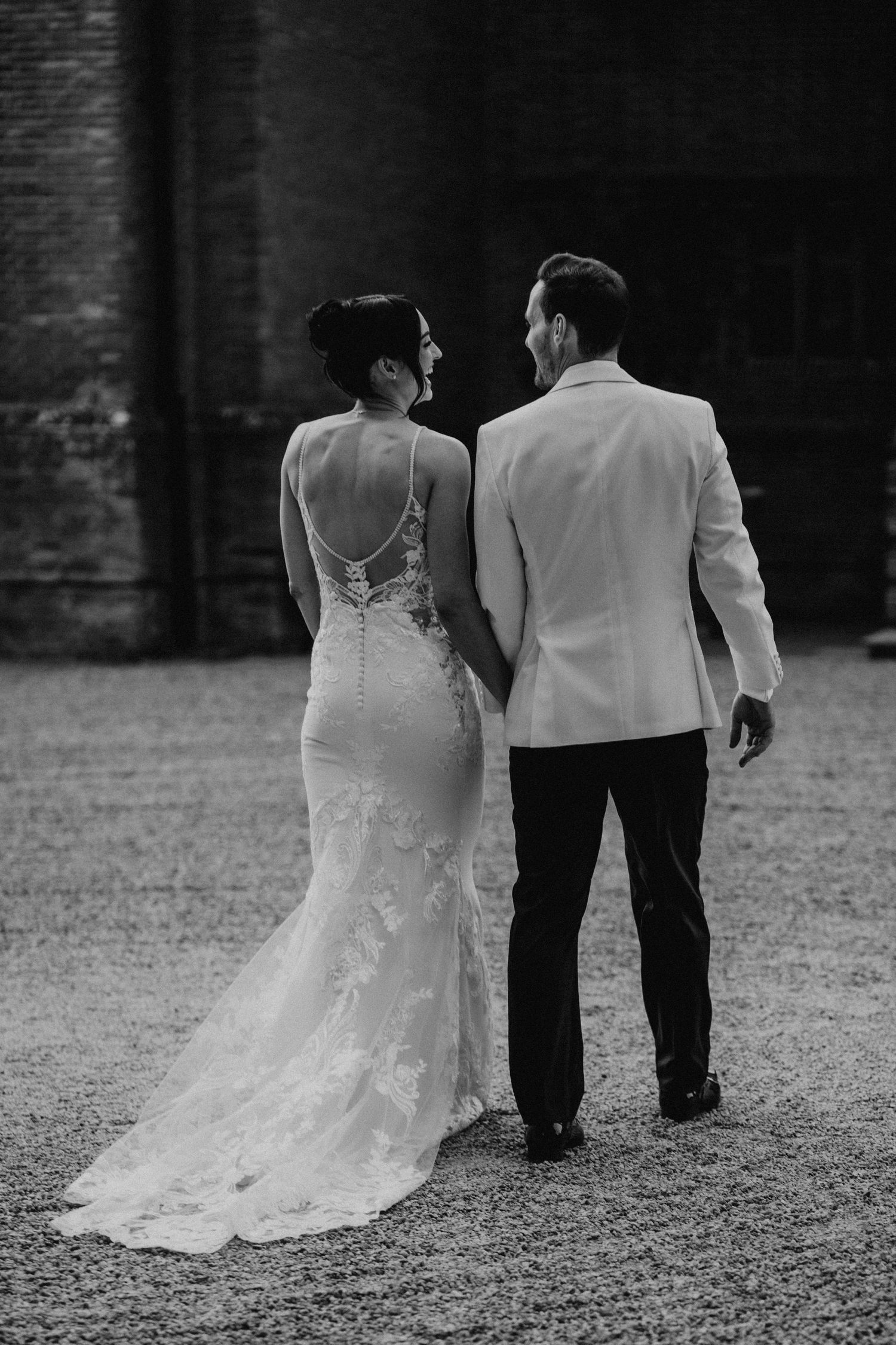 A series of black and white wedding photos showing a couple walking away, with focus on the bride's flowing lace train.