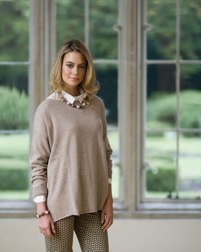 Stylish and fashionable young woman poses in mansion