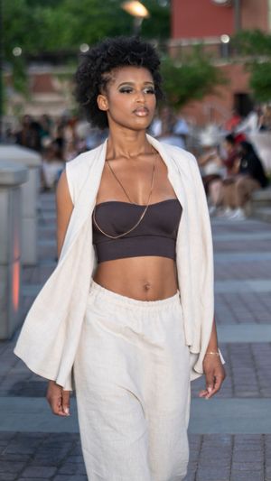 White linen ensemble with crop top and blazer styled for summer runway show.