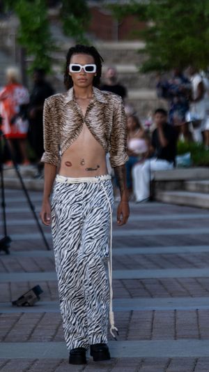 Fashion model wears animal print crop top with zebra print skirt on outdoor catwalk.