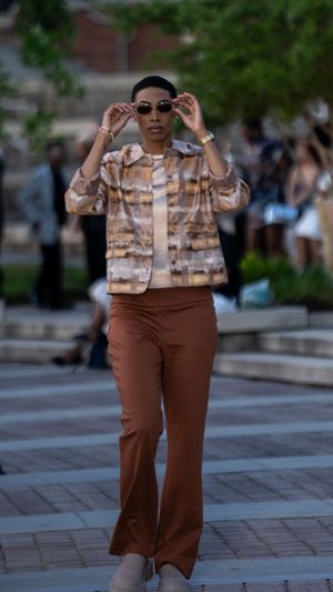 Brown wide-leg pants paired with patterned blouse for casual fashion showcase.