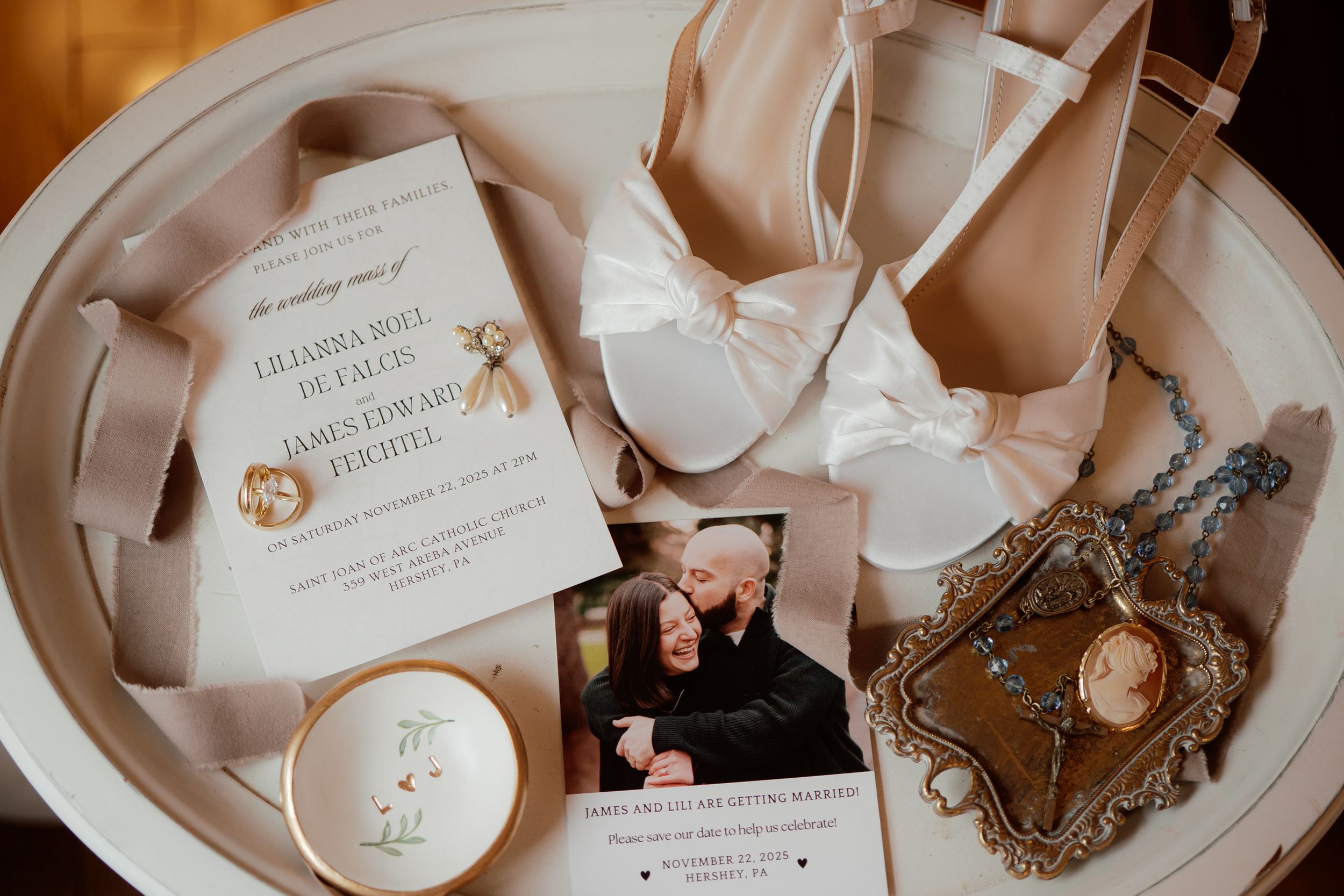 Wedding invitation suite and delicate details arranged in soft pink tones.