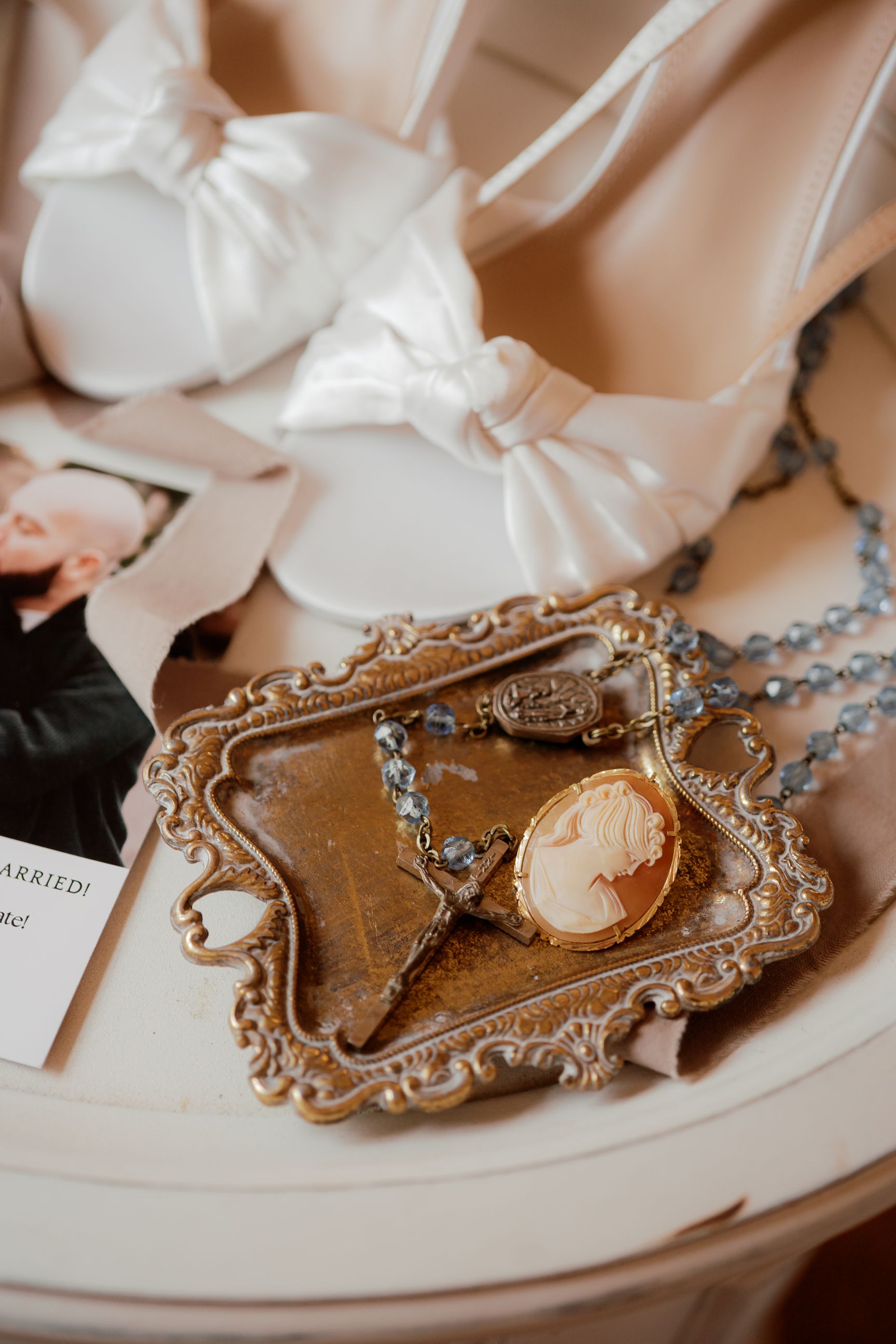 Vintage-style cameo brooches and decorative frames displayed on a light-colored surface.