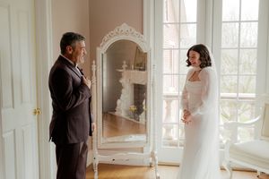 Elegant interior room with bright windows and ornate white decor for a special occasion.