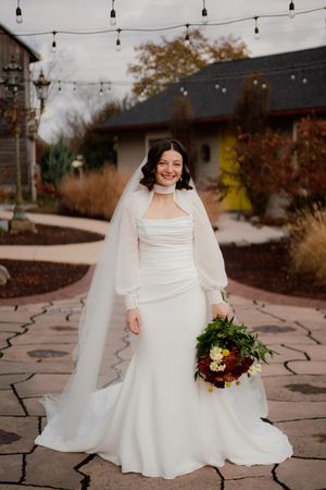 Outdoor wedding portraits with string lights and stone pathways at dusk.