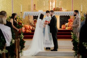 Traditional Catholic church wedding ceremony with altar and candles.