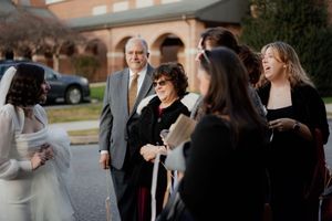 Wedding guests mingling during outdoor evening reception.