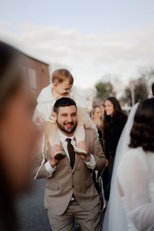Wedding celebration with guests cheering outdoors.