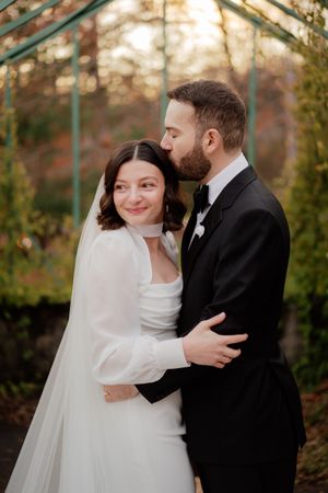 Intimate outdoor wedding portraits captured during golden hour among autumn foliage.