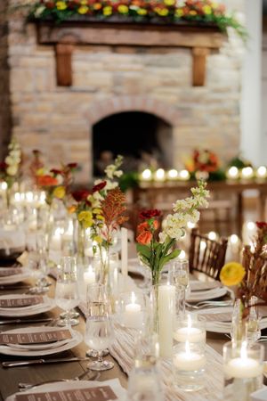Wedding reception tables decorated with delicate floral arrangements and candlelight.