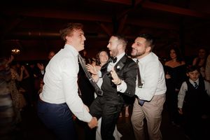 Lively dance floor scene with guests enjoying themselves at an evening wedding reception.