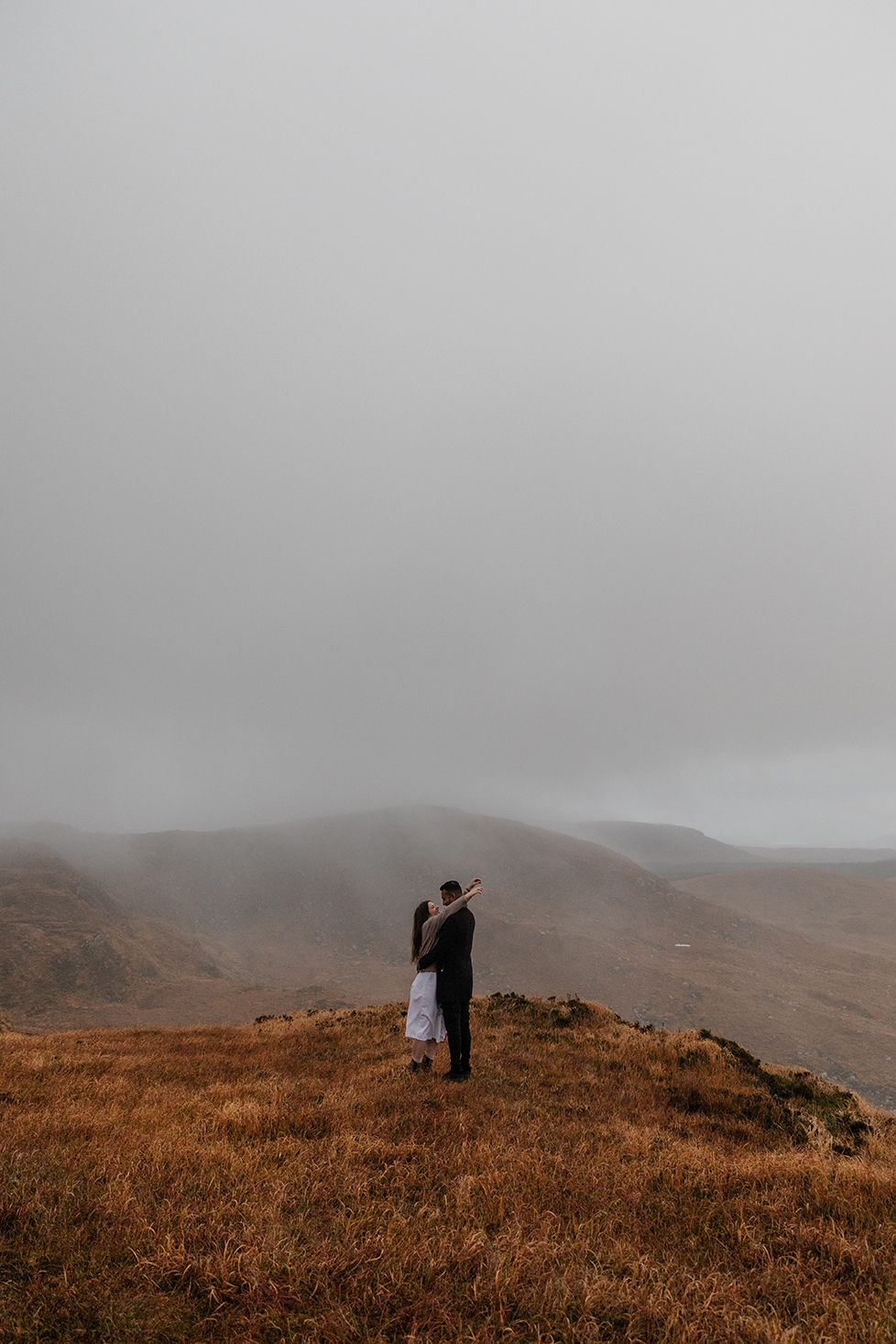 Misty mountains and winding road through Connemara landscape