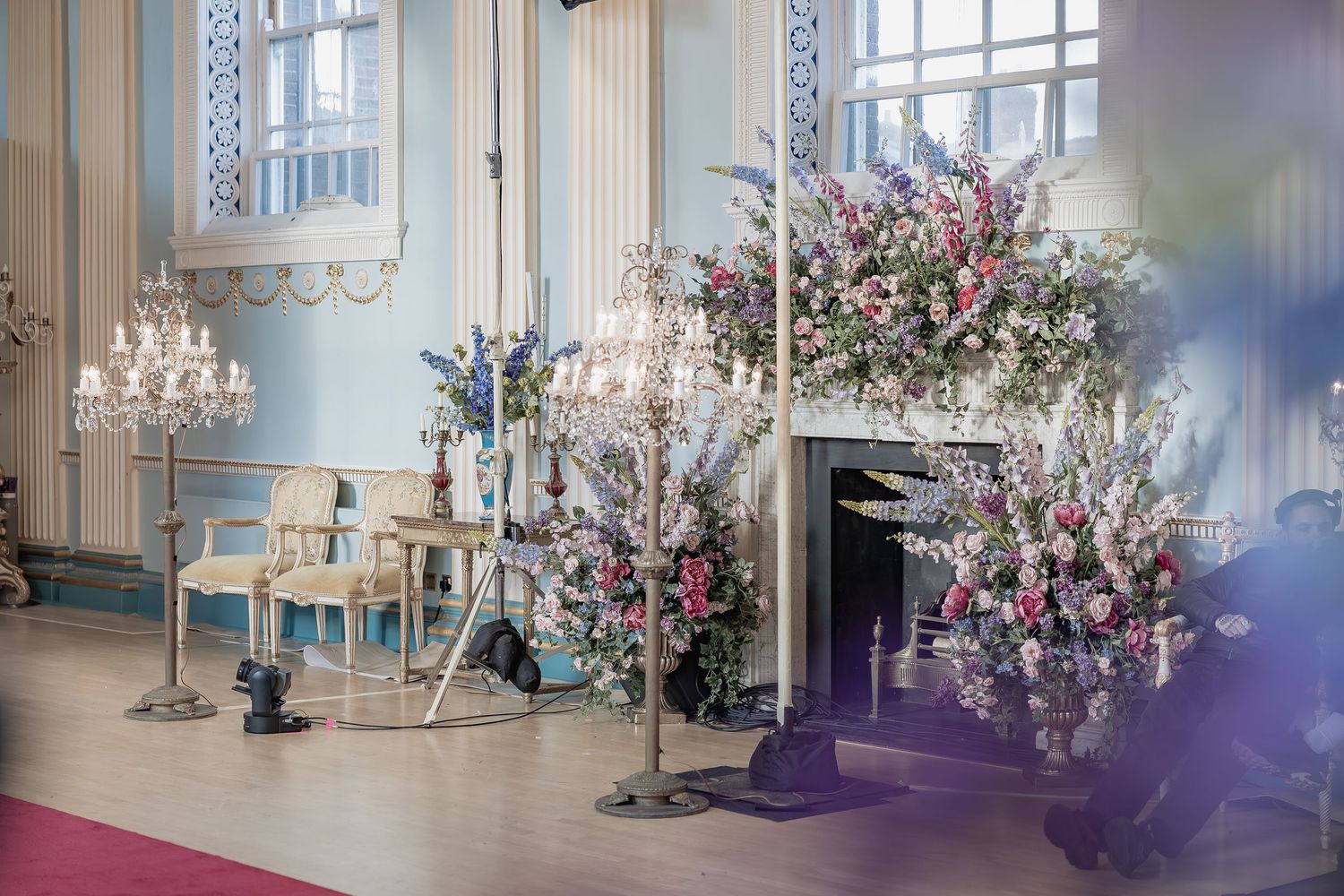 Behind the scenes of a Bridgerton Netflix filming setup at Newark Town Hall, showing the floral set up of the ballroom pre edit.