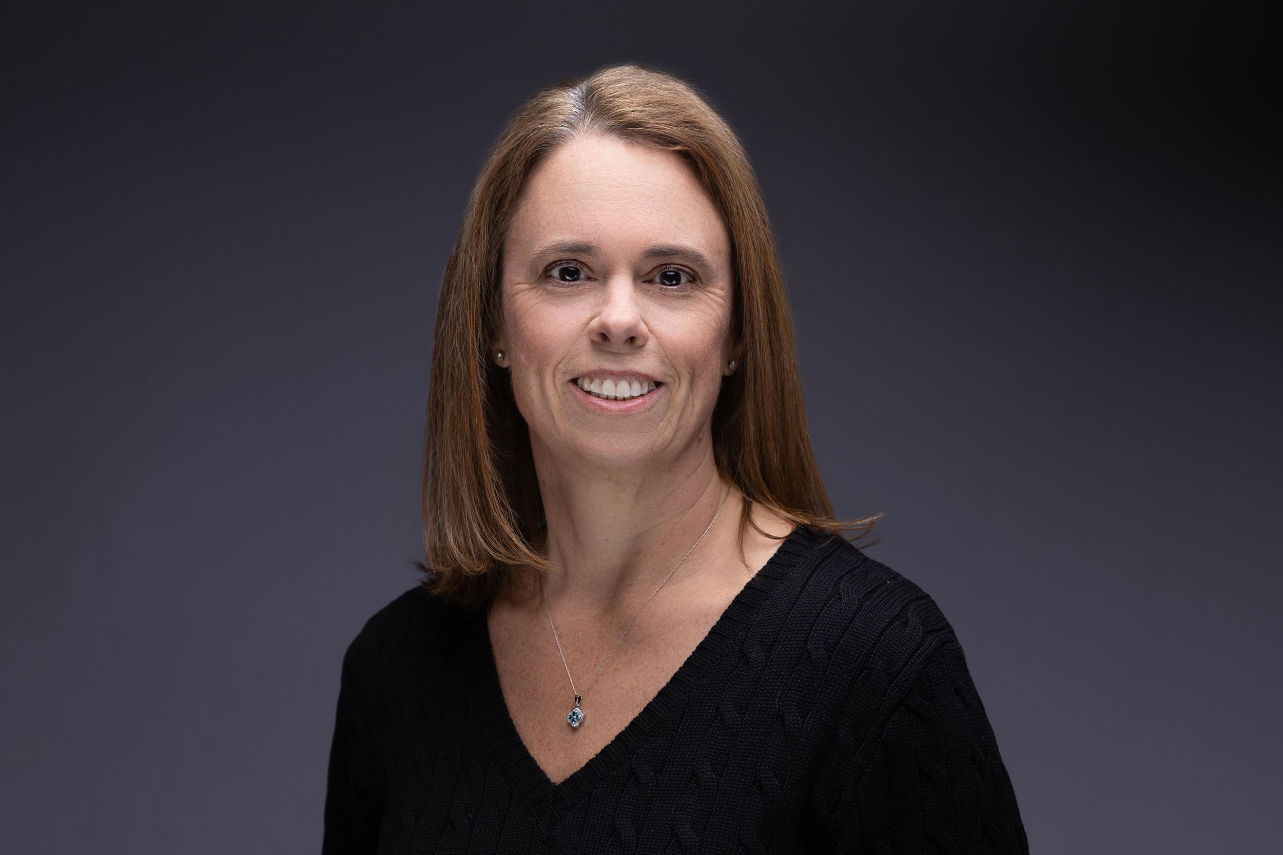 Professional headshot of a woman in a black sweater in Northern NJ