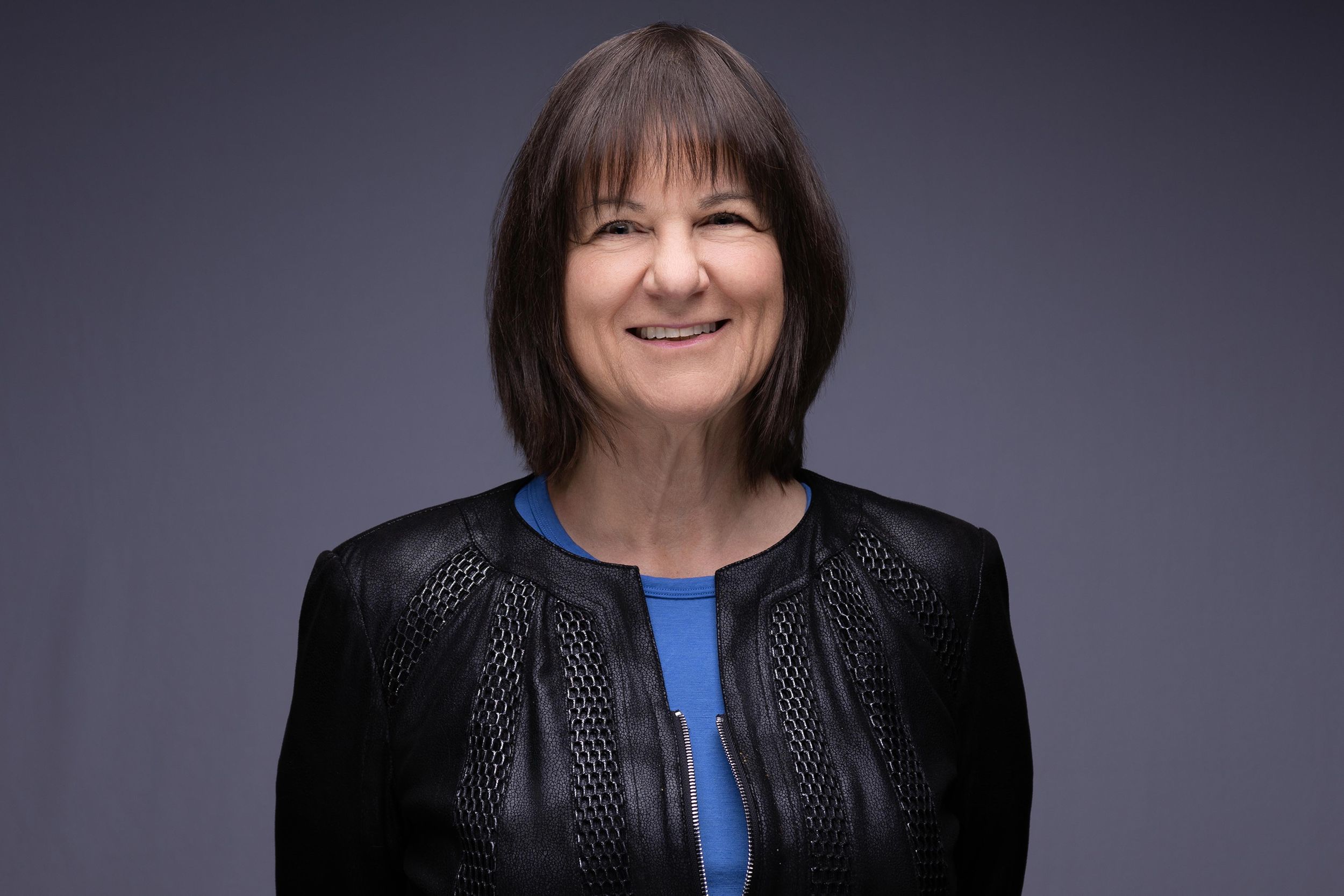 Professional headshot of a woman in a black leather jacket in Northern NJ
