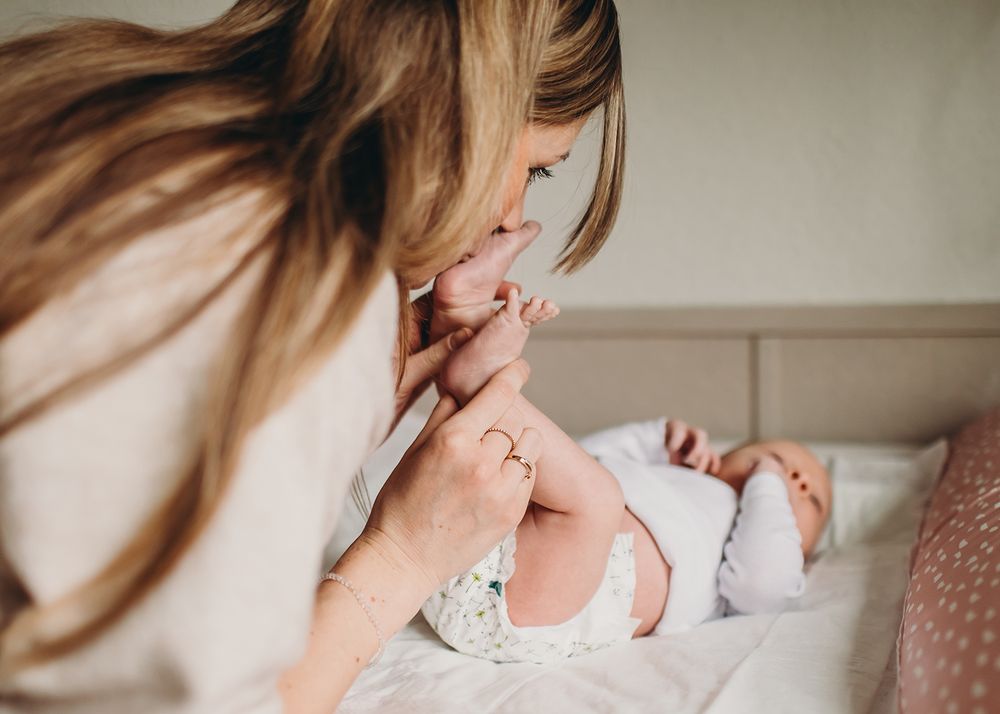 Series of tender moments showing gentle interaction with an infant against a neutral background.