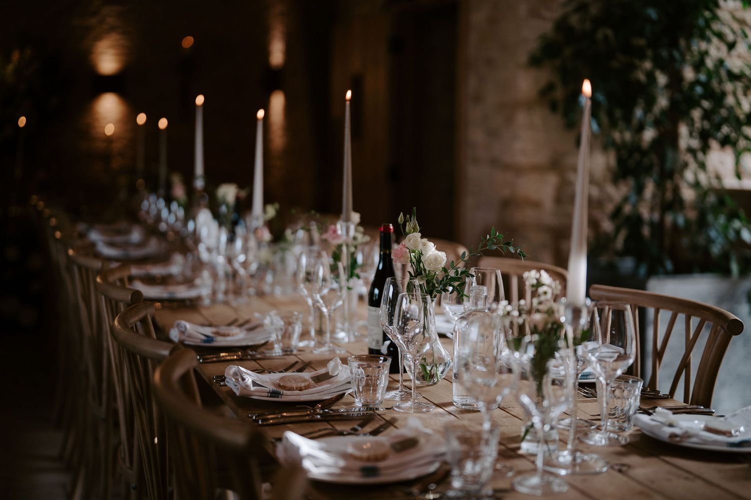 candles and flower arrangements decorating the wedding feast  barn at ivy lodge in cirencester