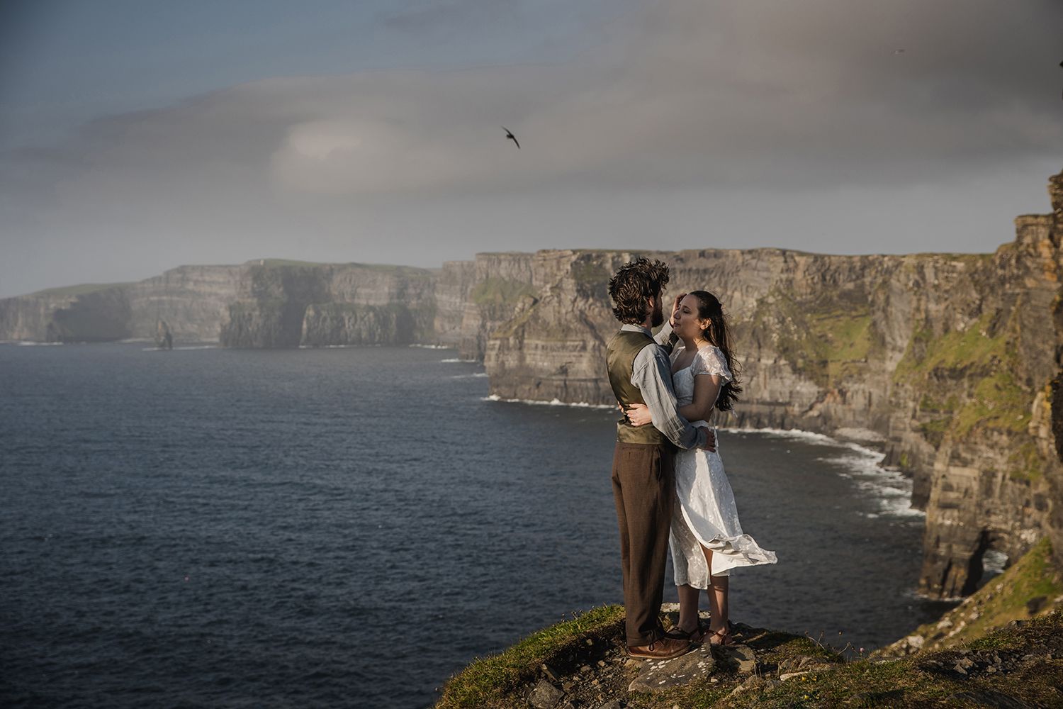 Romantic May elopement at the Cliffs of Moher with wildflowers and ocean sunset views