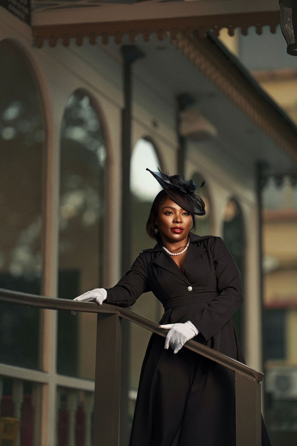 A sequence of dramatic poses captured in a classic architectural setting featuring black attire and white gloves.