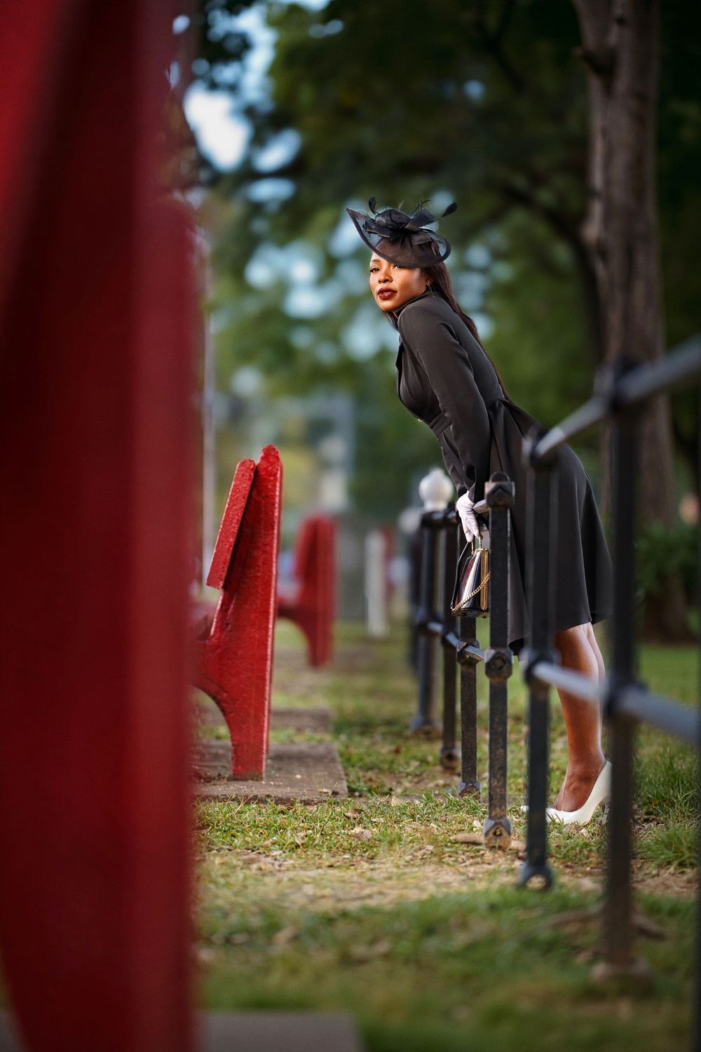 A series of photos showing someone in graduation attire walking past red posts and iron railings in an outdoor setting.