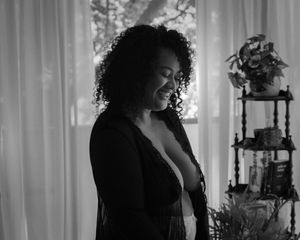 A black and white photo series showing a person singing emotionally in front of white curtains.