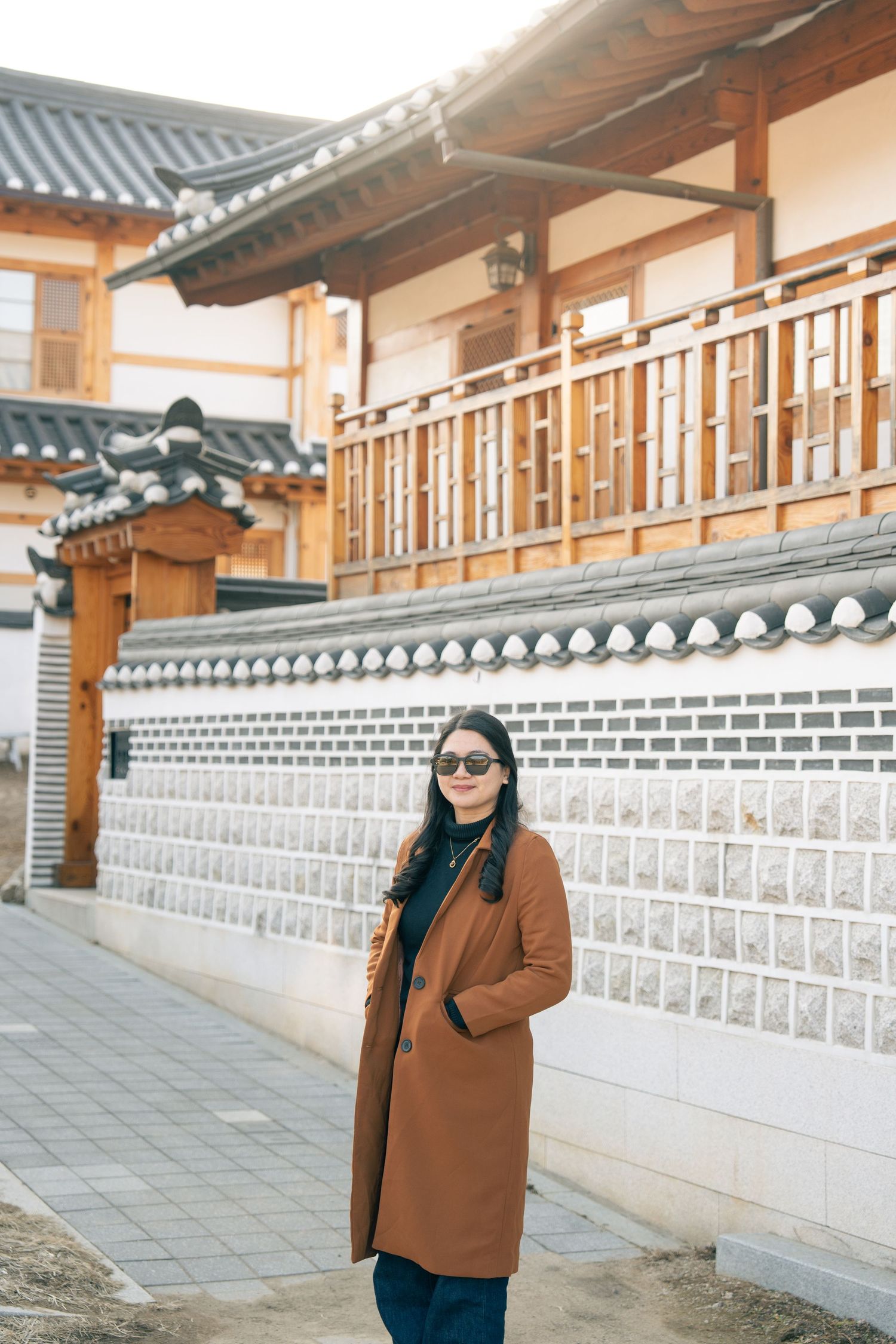Traditional Korean palace architecture with ornate white walls and wooden details creates a serene cultural backdrop.