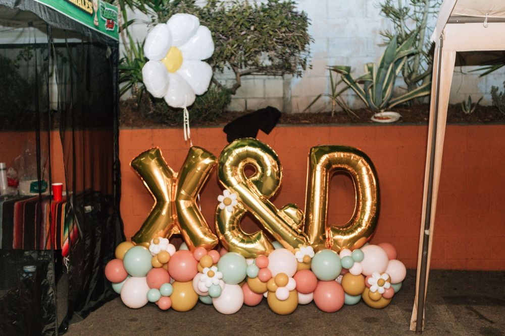 Balloons featuring the couples initials X and D with a balloon bouquet and archway for wedding reception in Los Angeles.