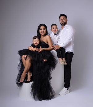 Studio photoshoot featuring dramatic black tulle outfits against grey backdrop.