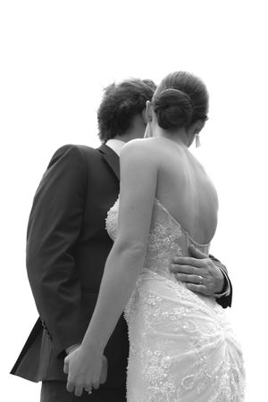 Black and white portrait of bride and groom in an intimate embrace at their wedding.