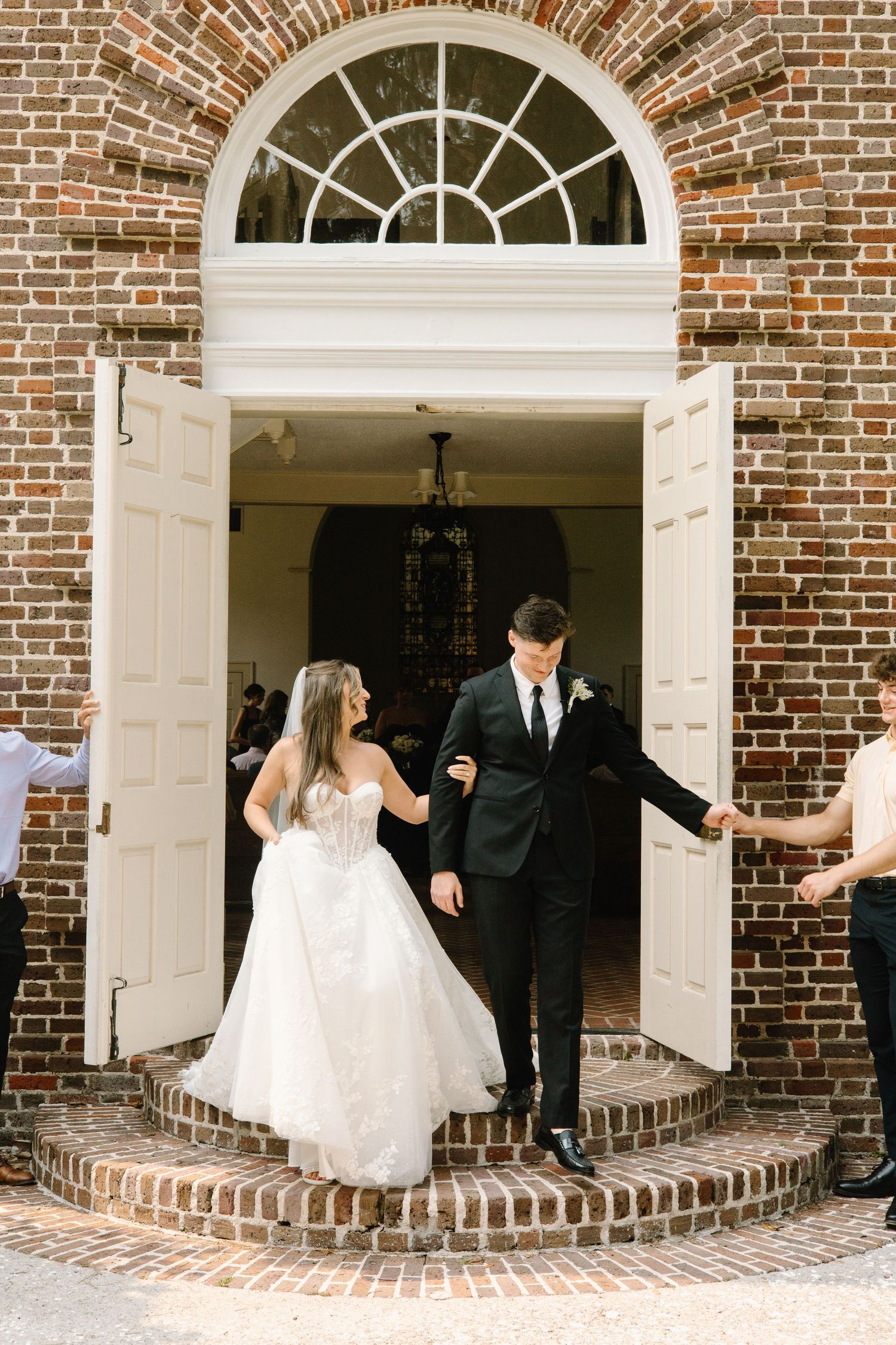 Romantic sequence of wedding couple playfully peeking and hiding behind elegant brick archways at a historic venue.
