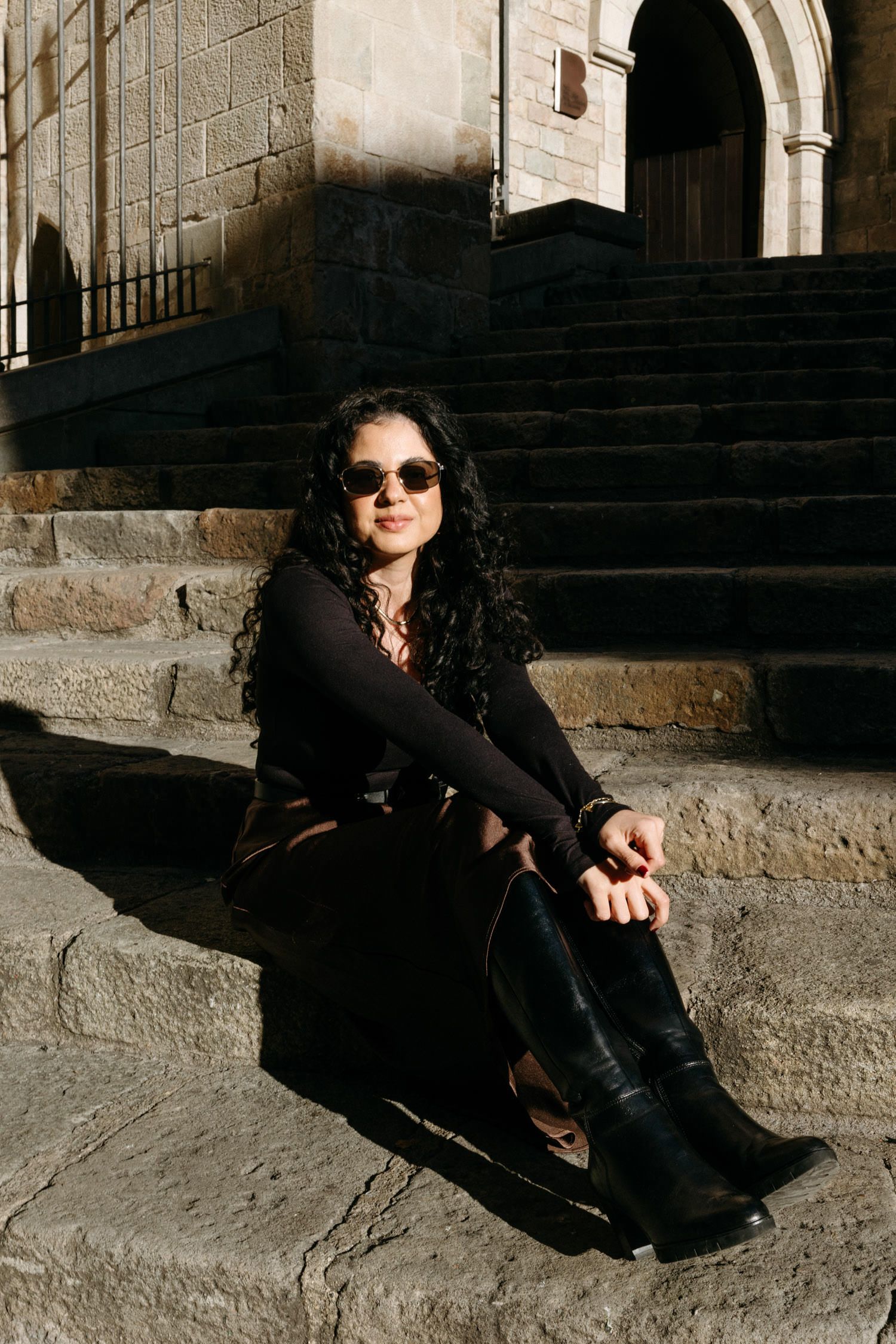 Stone steps and archways in a historic European city setting with dramatic lighting.