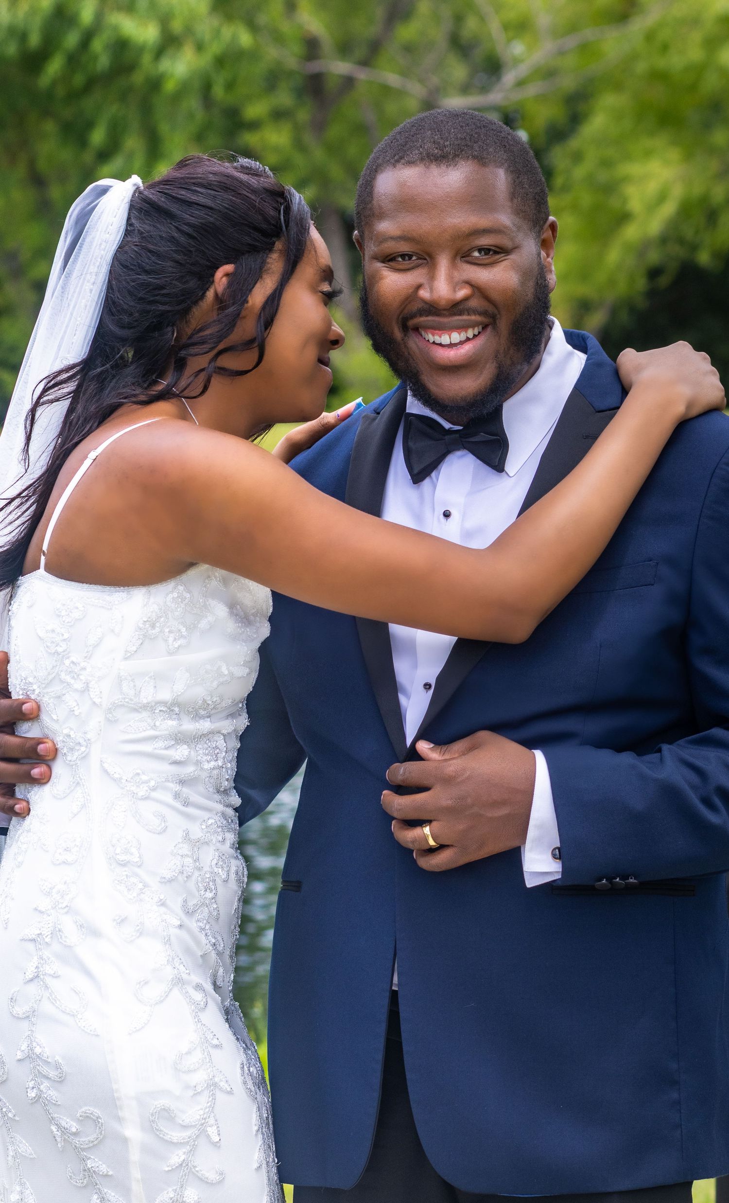 Elegant Black bride and groom sharing a joyful moment on their wedding day, showcasing beautiful wedding photography celebrating love