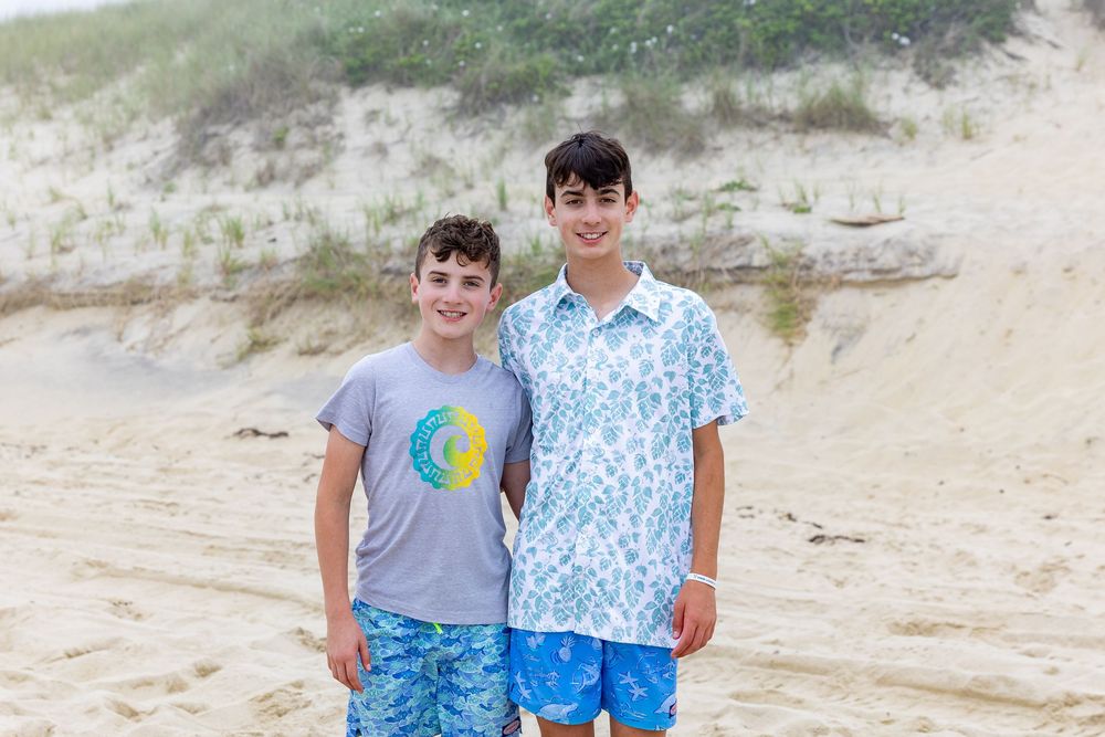 Two people wearing casual summer clothing for a photo at Nobadeer beach on Nantucket, MA in the summer by Lisa West Photography.