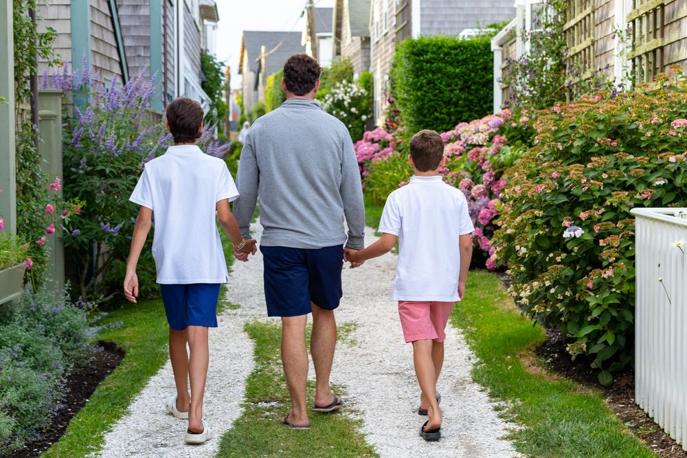 A father and sons walking together along Front St in Sconset on Nantucket, MA by Lisa West Photography www.lisawestphotography.com