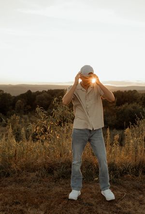 A sequence of sunset portraits in a golden field showing playful poses against the warm evening light.